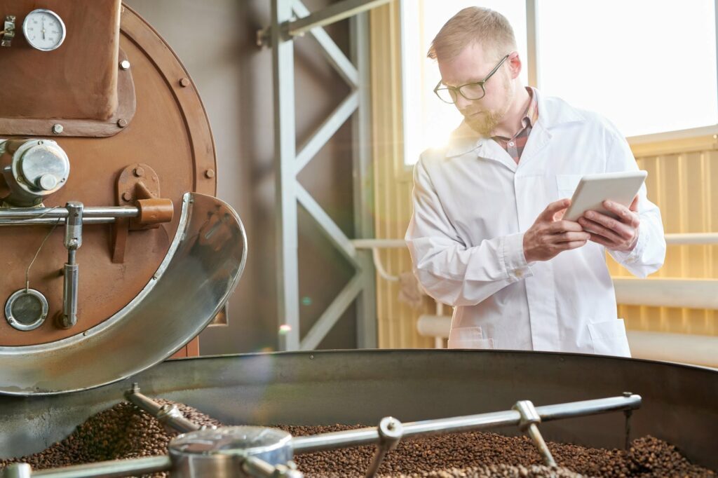 Worker Roasting Coffee at Factory